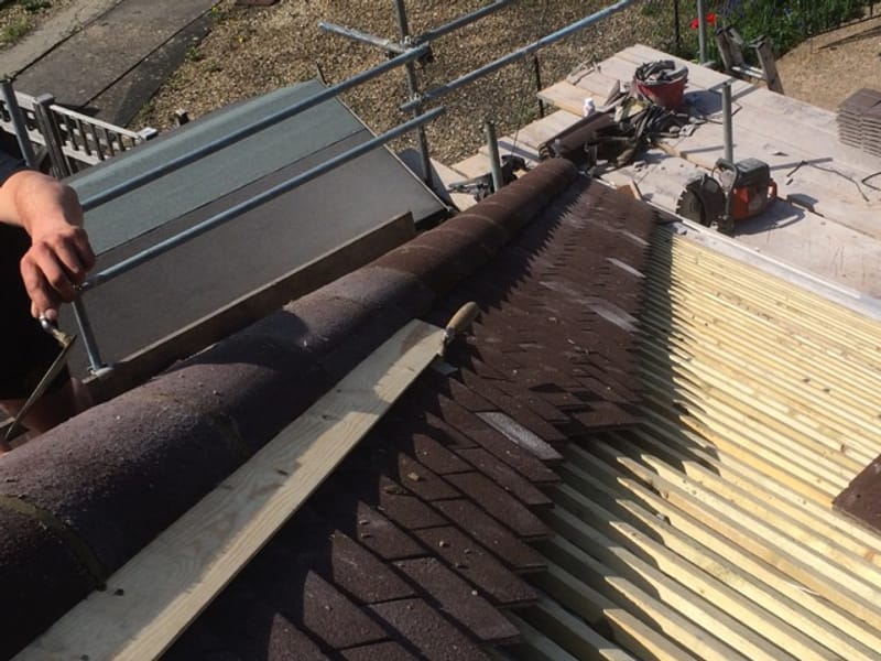 Velux window being fitted on a slate roof in Gloucestershire